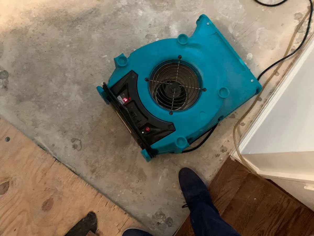 Air mover drying subfloor during Commercial Water Damage Restoration in West Springfield Town